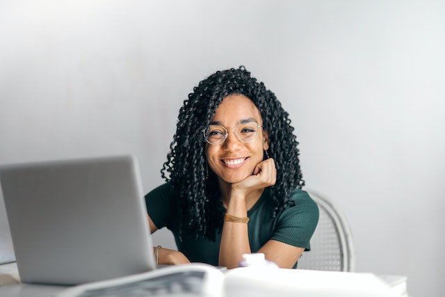 smiling young woman working on a laptop