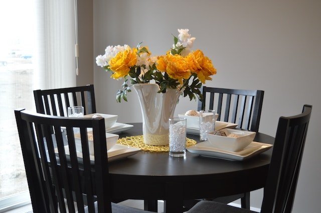 black dining table with yellow flowers