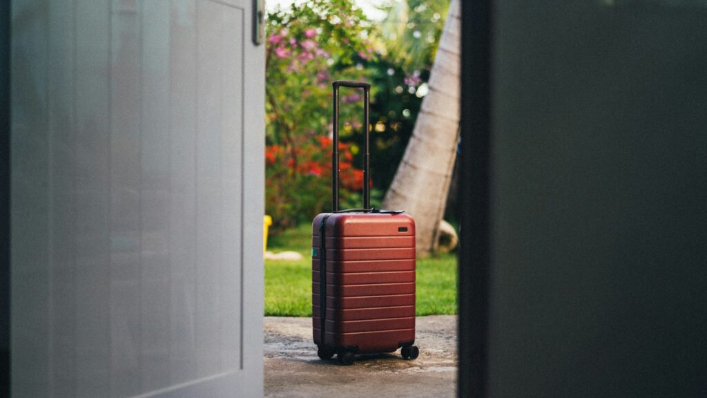 Guest leaving a vacation rental, illustrating cancellation policy Airbnb scenarios