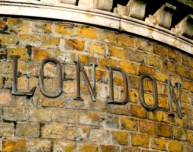 Historic brick wall with 'London' sign representing Airbnb regulations in London